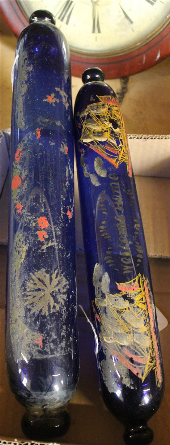 Two Bristol blue glass rolling pins, one painted ships, the other flowers